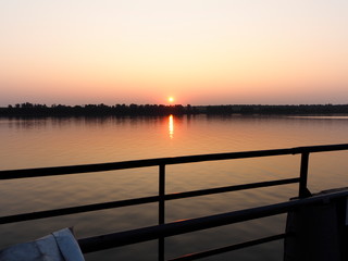 sunset over calm water surface