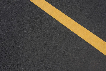 Fototapeta premium Yellow paint slash mark top view text space on black asphalt road