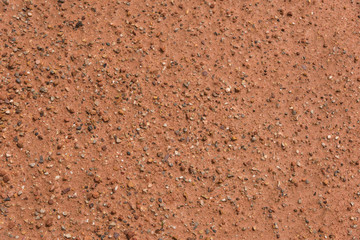 Orange hard earth with gravel background texture