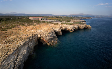 Fototapeta na wymiar Aerial view on coastal rocks with natural sea caves near Spilies beach on Crete, Greece.