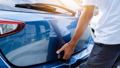 Man open hatchback car for trunk his press button transportation technology system convenient,...