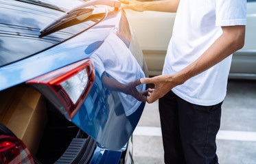 Man open hatchback car for trunk cardboard box parcel delivery transportation technology system...