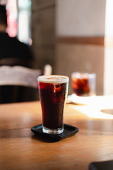 Nitro cold brew coffee on wooden table , coffee shop background