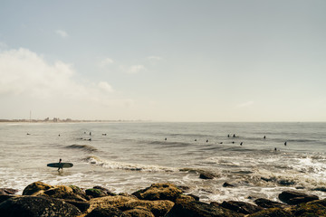 Surfers in the sea, on the coast of Matinhos, Paraná, Brazil