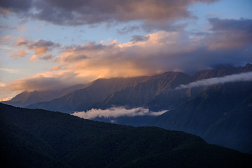Fototapeta na wymiar Mountain ranges in the clouds at sunset.