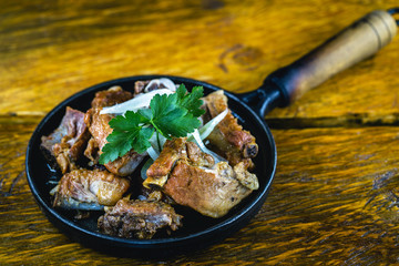 Pork rib served on hot plate, restaurant food.
