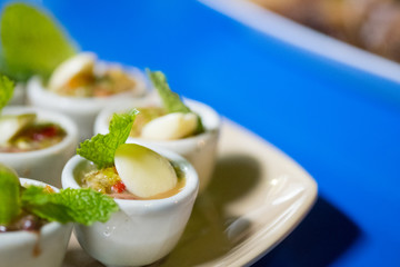 Fresh blood cockle or blood clam in spicy seafood sauce served in mini cup.