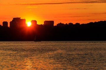 Fototapeta premium Orange sunset over a river in Kiev, Ukraine