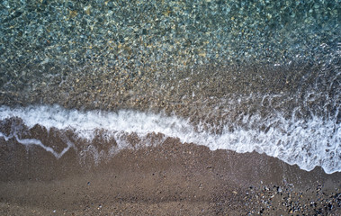 Aerial image of pebble beach. Camera looks straight down