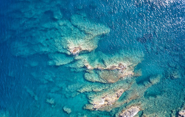 Aerial view on underwater reefs in mediterranean sea with clear transparent water. Crete, Greece