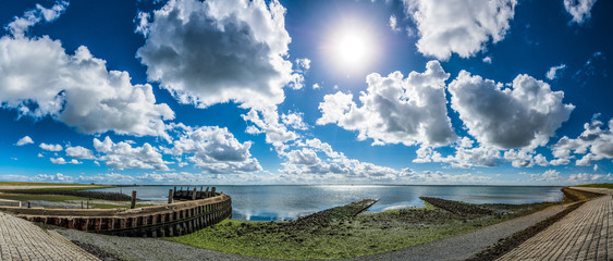 Obraz premium Wolken und Sonne am Meer