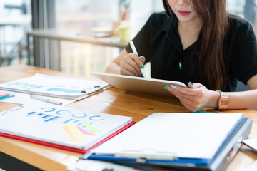 Cropped shot of young business woman making business plan meeting notes in tablet. Business analysis and strategy concept