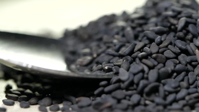 Pouring black sesame seeds in slow motion