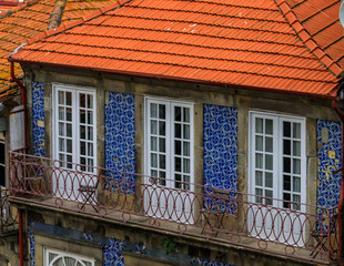 Facades of traditional houses decorated with ornate Portuguese azulejo tiles in Porto, Portugal