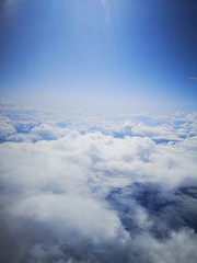 Fototapeta premium Cotton clouds from the plane's eiumator