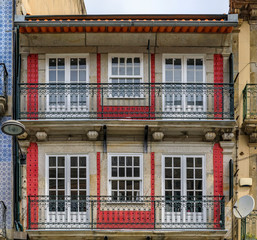 Facades of traditional houses decorated with ornate Portuguese azulejo tiles in Porto, Portugal