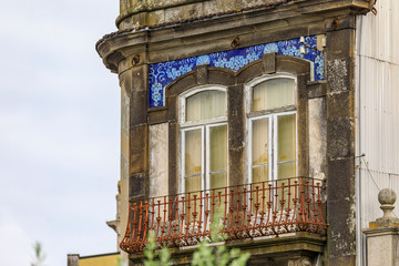 Facades of traditional houses decorated with ornate Portuguese azulejo tiles in Porto, Portugal