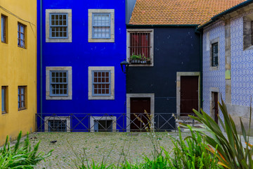 Facades of traditional houses decorated with ornate Portuguese azulejo tiles in Porto, Portugal