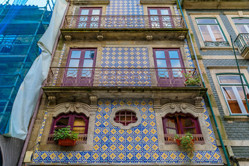 Facades of traditional houses decorated with ornate Portuguese azulejo tiles in Porto, Portugal