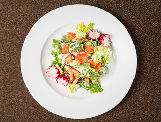 salad with fresh vegetables on the white plate