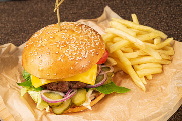 burger with french fries on parchment