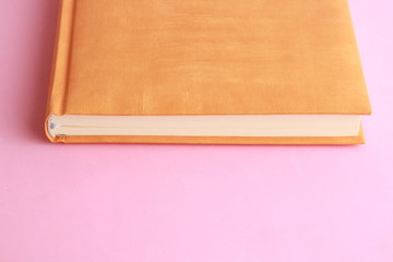 book with orange cover on colorful background