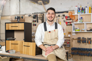 furniture factory, Small-Sized Companies and people concept - Portrait of a smiling male worker at...