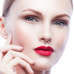 Fototapeta premium Close-up beauty face of young sexy fashon model woman with red lips bright make-up, healthy perfect skin, hand near cheek
