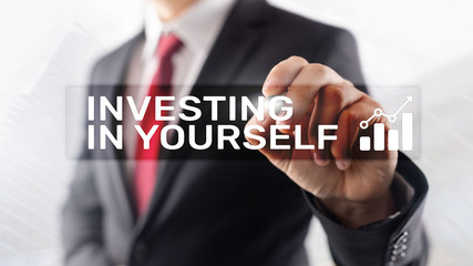 Invest in yourself. Personal development and education concept on abstract blurred background