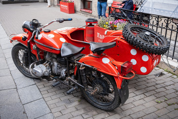 motorcycle with sidecar painted red and with white dots