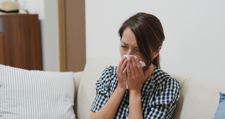 Woman suffer from influenza, sneeze at home