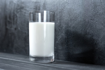 glass milk on black background