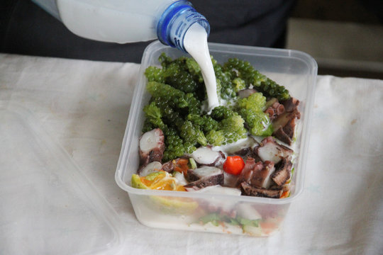 Traditional fijian Octopus salad with coconut milk and Nama (seagrass that looks like tiny grapes)