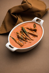 Hyderabadi Bhindi ka Salan or Okra salan made using ladies' fingers or ochro. Main course recipe from India. served in a bowl. selective focus