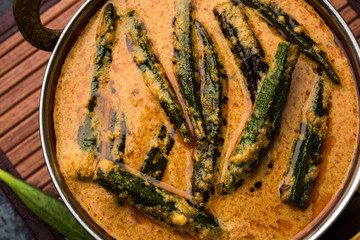 Hyderabadi Bhindi ka Salan or Okra salan made using ladies' fingers or ochro. Main course recipe from India. served in a bowl. selective focus
