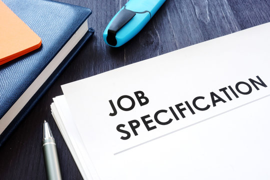 Job specification on the black desk and pen.