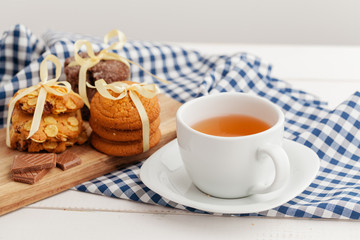 Homemade crunchy cookies and  tea on a wooden table
