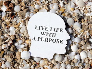Wooden head with inscription Live life with a purpose.