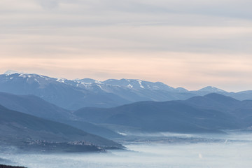 A view of Umbria valley with hills and mist