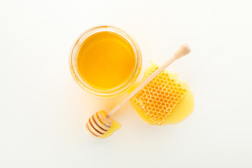 Fototapeta na wymiar Glass jar, honeycomb and dipper isolated on white background