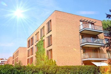 Modern apartment buildings on a sunny day with a blue sky. Facade of a modern apartment building.Glass surface with sunlight.