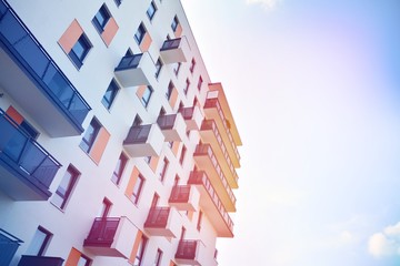 Modern apartment buildings on a sunny day with a blue sky. Facade of a modern apartment building.Glass surface with sunlight.