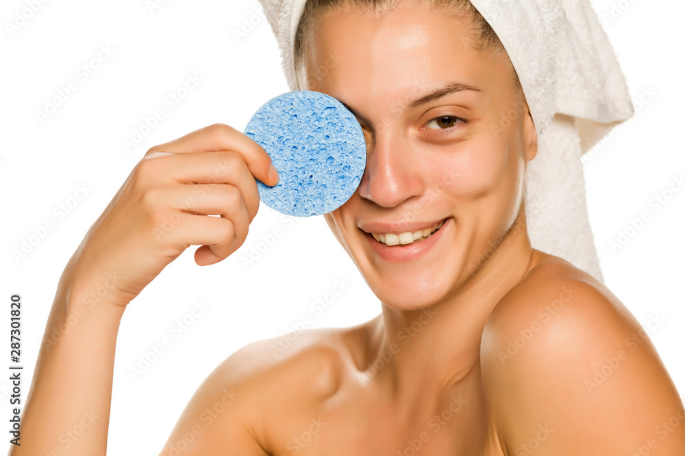 Sticker young beautiful woman posing with a sponge pad on the white background