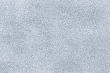 Background of light gray suede fabric closeup. Velvet matt texture of silver nubuck textile