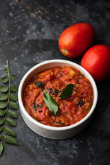 Tomato/tamatar chutney or sauce, served in a bowl. selective focus
