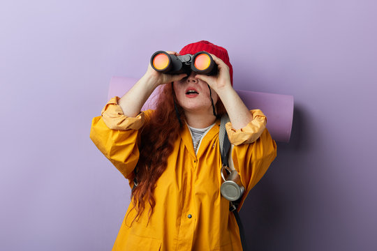 awesome curious traveler watching flying unusual birds in the sky. close up portrait, isolated blue background, studio shot, inspirataion concept