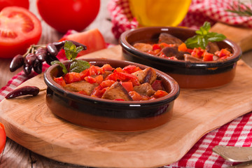 Marinated pork loin in tomato sauce. 