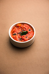 Tomato/tamatar chutney or sauce, served in a bowl. selective focus