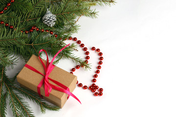 Christmas composition with a branch. Christmas tree and gift box on white background.