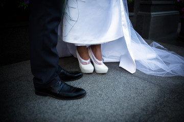 Obraz na płótnie Canvas Photo of the legs of the bride and groom